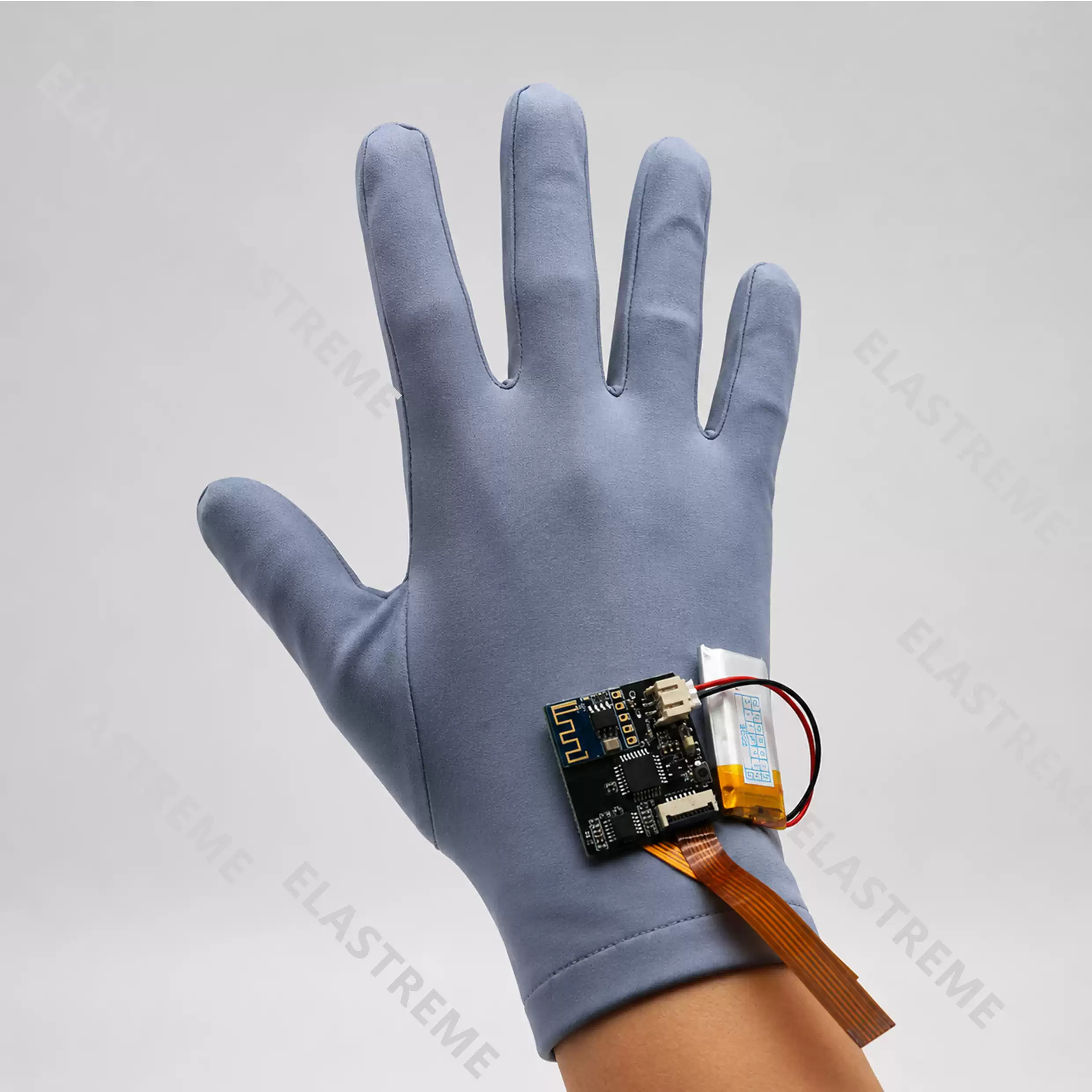 Elastreme Sense Manu-5D Electronic Skin and Data Glove — Manu-5D glove worn on a hand with acquisition board and battery at the wrist.